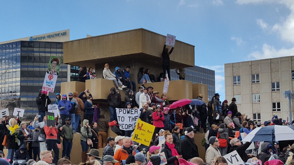 Photo of protest. "Power to the people" sign in center