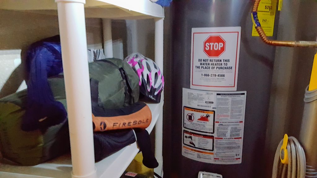 Messy closet with bike helmet on shelf